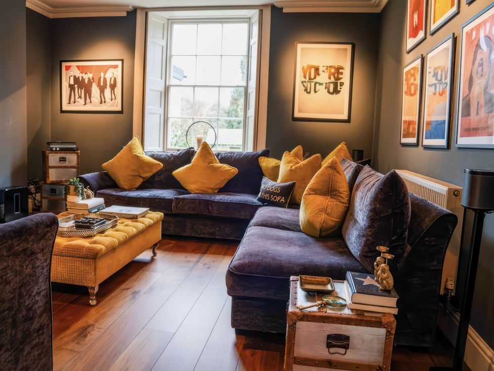 A living room with a large sofa and coffee table at St Anne's Manor in Torquay