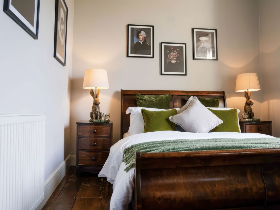 A bedroom with a bed and lamp at St Anne's Manor in Torquay