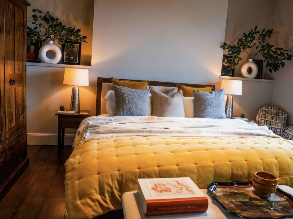 A bedroom with a bed, nightstand, and wardrobe at St Anne's Manor in Torquay