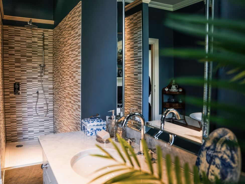 A bathroom with a shower and sink at St Anne's Manor in Torquay