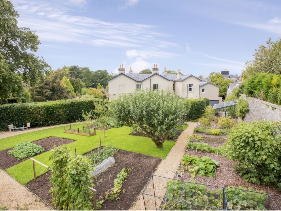 A garden with vegetable beds and a pathway at St Anne's Manor in Torquay