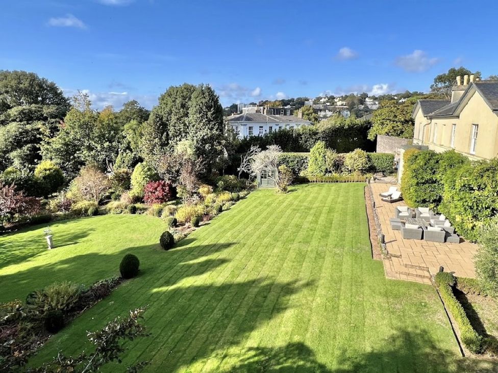 A garden with a lawn and seating area at St Anne's Manor in Torquay