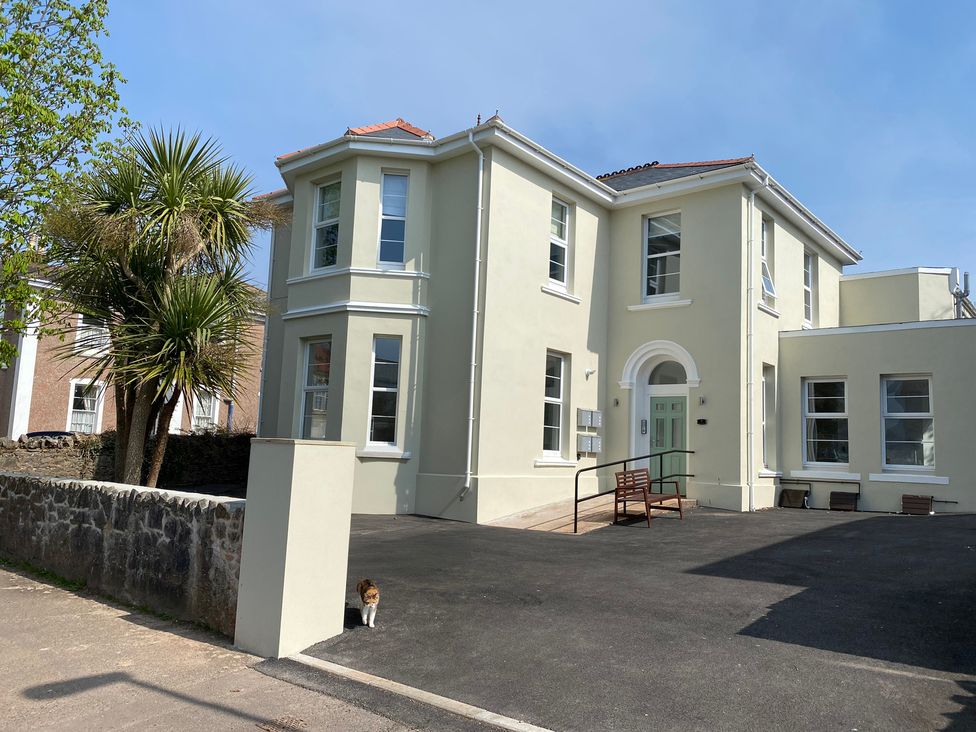 A building with windows and driveway at The Falstone Apartment in Torquay