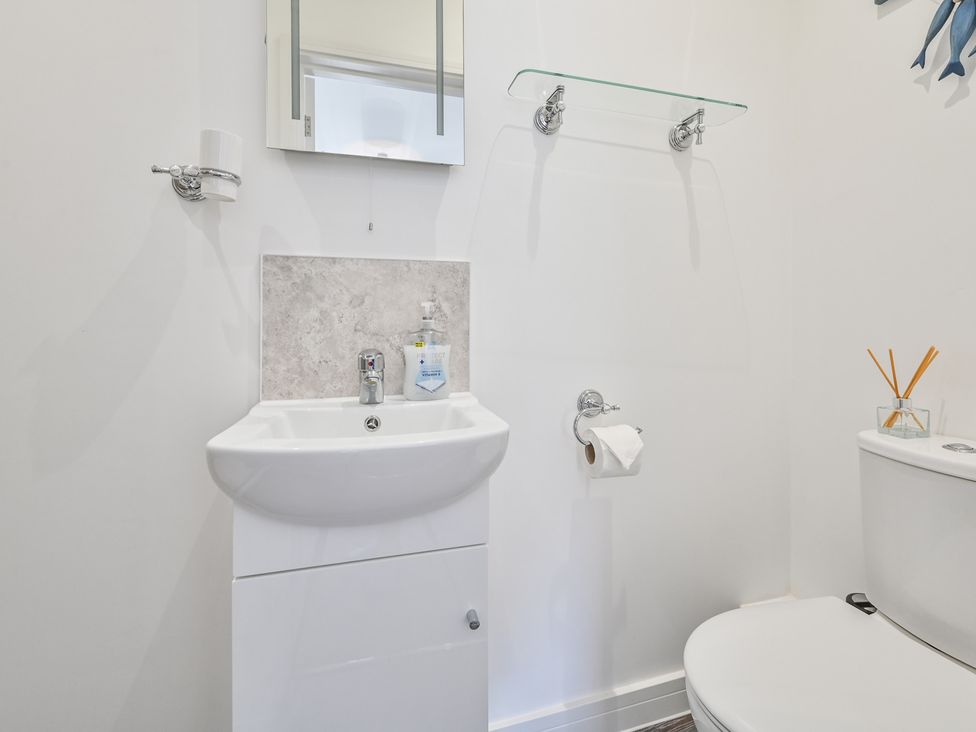 A bathroom with a sink and toilet at The Falstone Apartment in Torquay