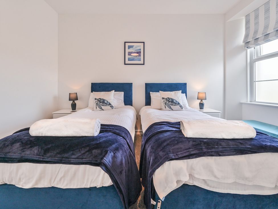 A bedroom with two single beds and a window at The Falstone Apartment in Torquay