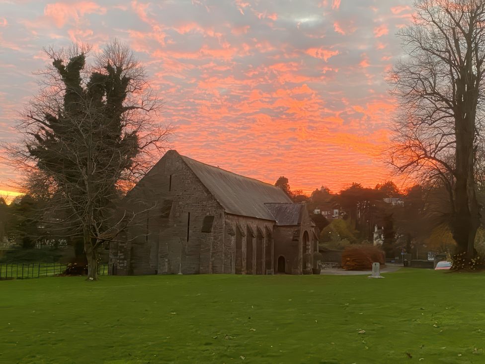 An outdoor view of a church at sunset at Lower Stable - The Stables Apartments at Meadfoot Bay Torquay
