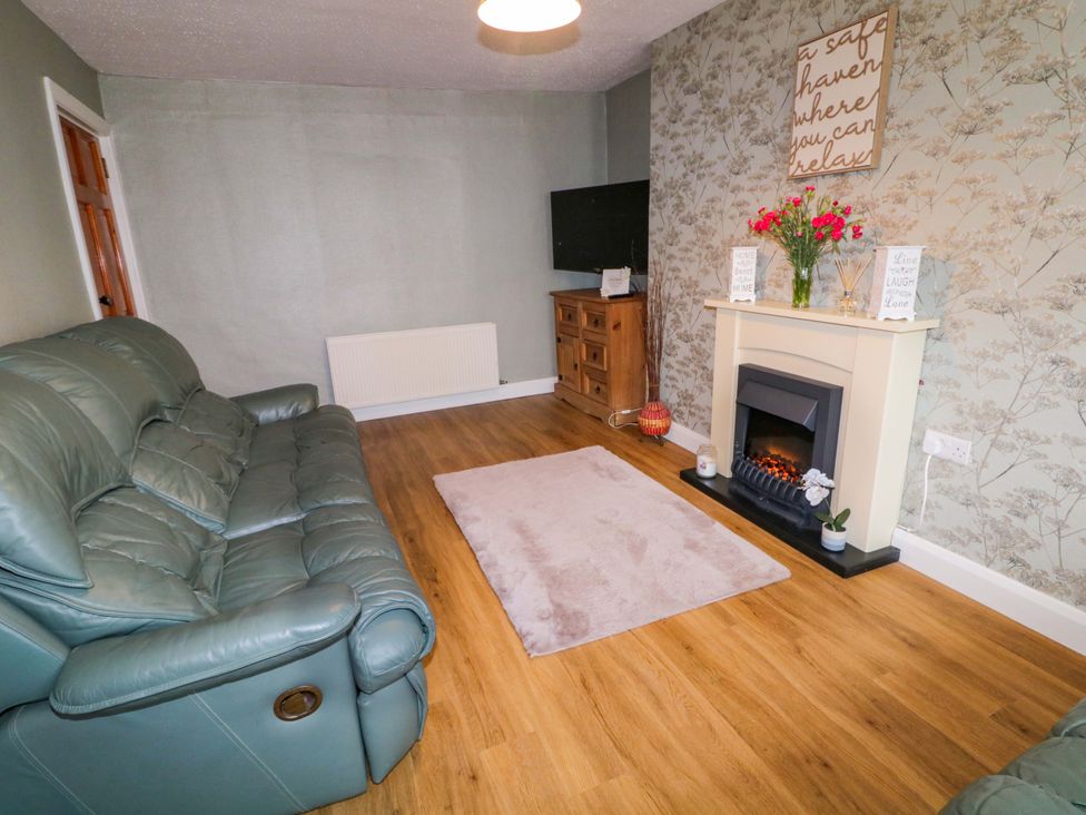 A living room with a sofa and fireplace at 4 Bed Property in Northern Ireland Garrison, County Fermanagh