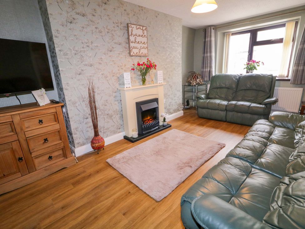 A living room with a television and a sofa at 4 Bed Property in Northern Ireland, Garrison, County Fermanagh