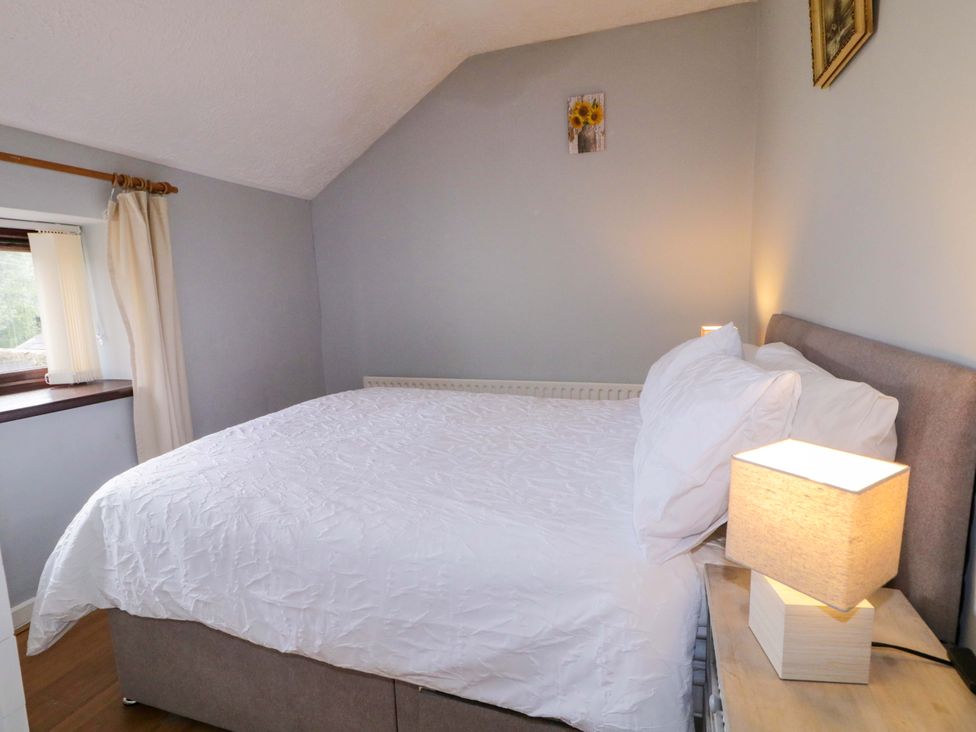A bedroom with a bed and lamp at 4 Bed Property in Northern Ireland, Garrison, County Fermanagh