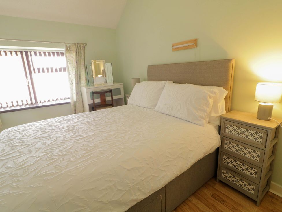 A bedroom with a bed and bedside table at 4 Bed Property in Northern Ireland, Garrison, County Fermanagh
