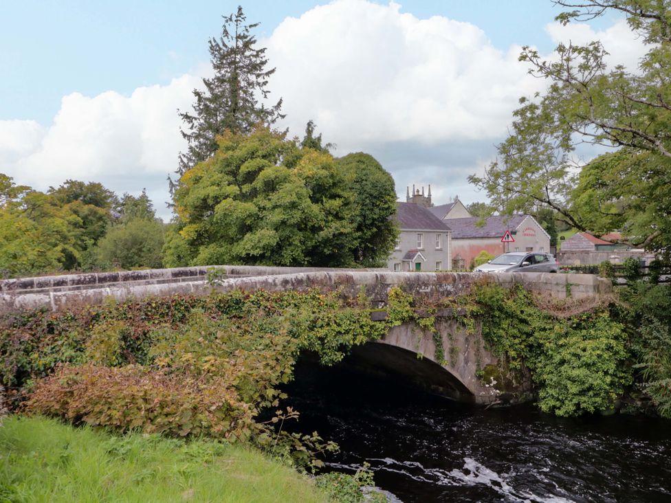 A bridge over a river with trees and buildings nearby at 4 Bed Property in Northern Ireland Garrison, County Fermanagh