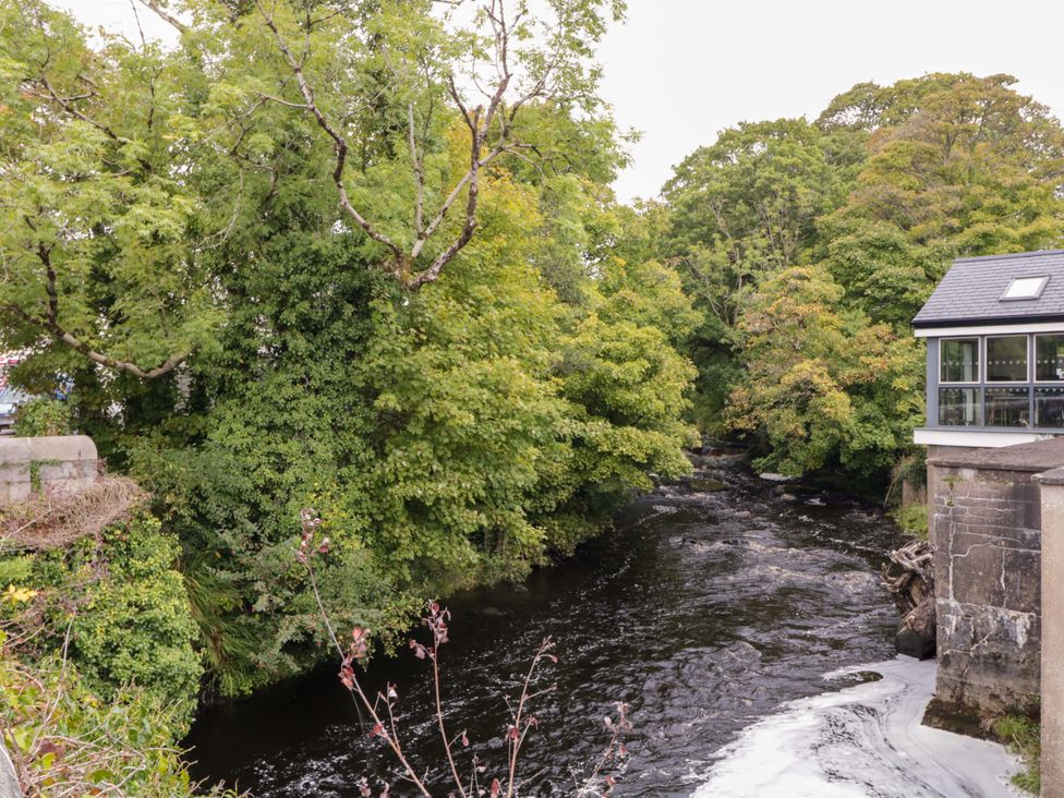 A river surrounded by trees and a building at 4 Bed Property in Northern Ireland in Garrison, County Fermanagh
