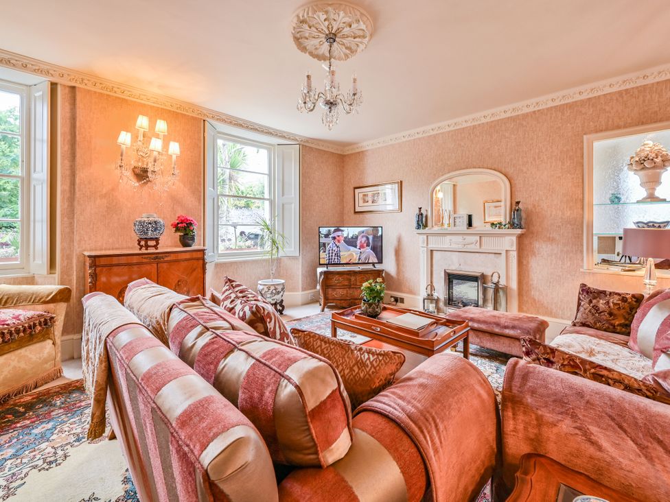 A living room with a sofa and a television at Muntham Luxury Town House with Hot Tub, Torquay