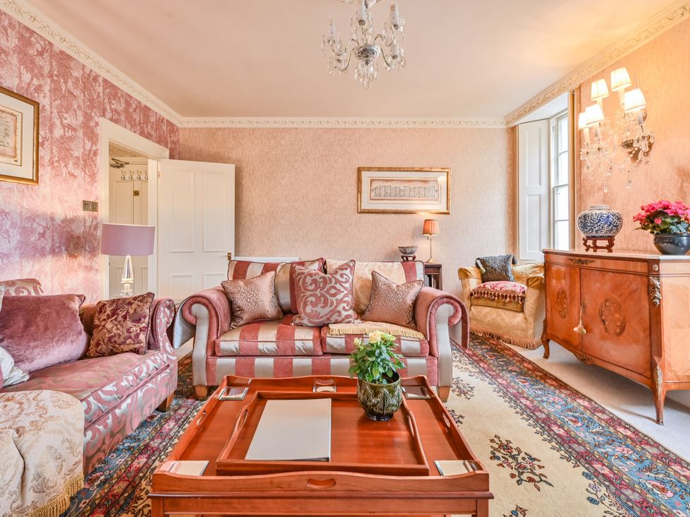 A living room with a sofa and armchair at Muntham Luxury Town House with Hot Tub in Torquay