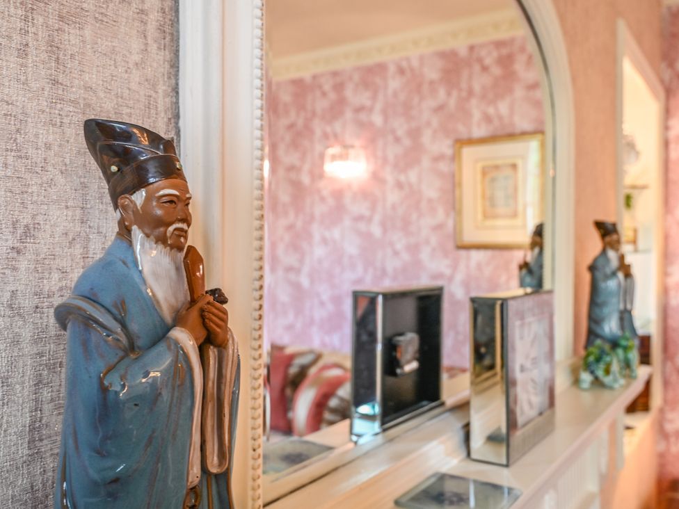 A living room with a statue and mirror at Muntham Luxury Town House with Hot Tub Torquay