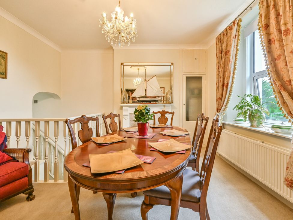 A dining room with a table and chairs at Muntham Luxury Town House with Hot Tub in Torquay