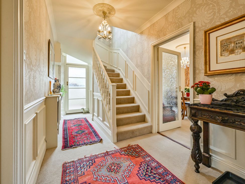 A hallway with a staircase and decorative items at Muntham Luxury Town House with Hot Tub Torquay