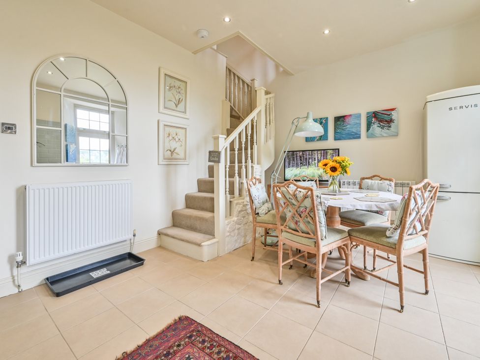 A dining area with a table and chairs at Muntham Luxury Town House with Hot Tub in Torquay