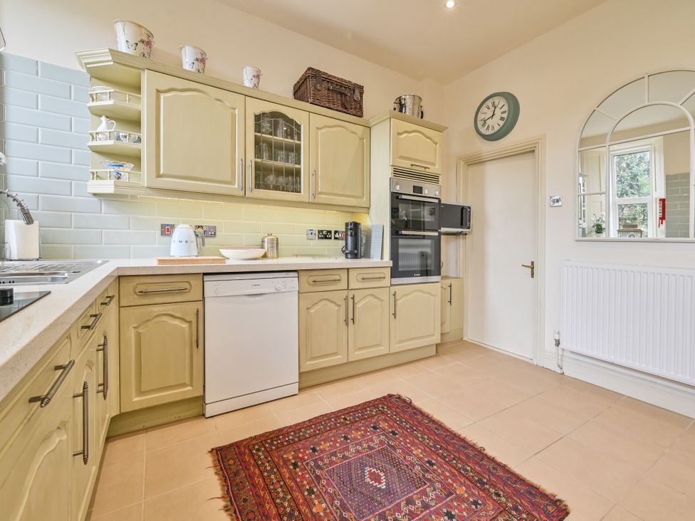 A kitchen with cabinets, a sink, and appliances at Muntham Luxury Town House with Hot Tub in Torquay