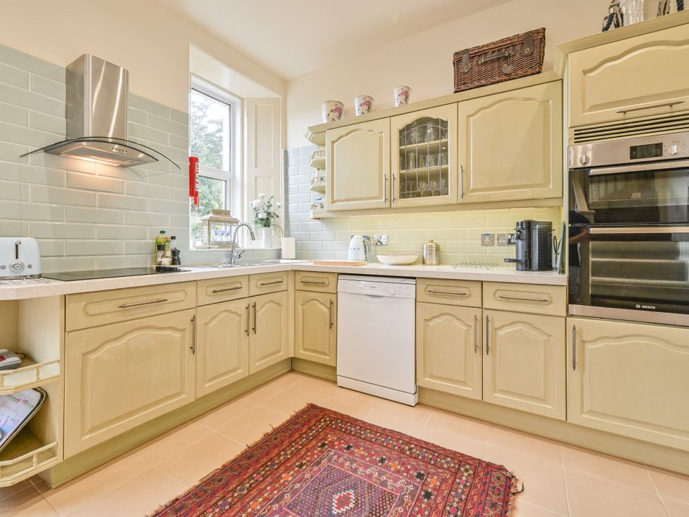 A kitchen with cabinets and appliances at Muntham Luxury Town House with Hot Tub in Torquay
