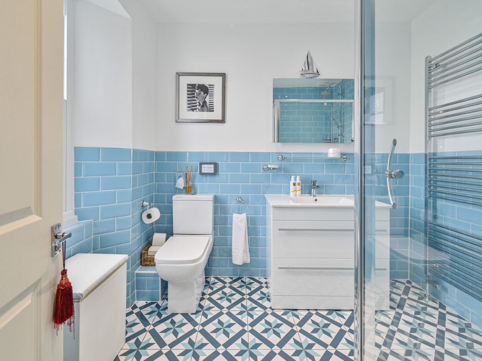 A bathroom with a toilet, sink, and shower at Muntham Luxury Town House with Hot Tub in Torquay