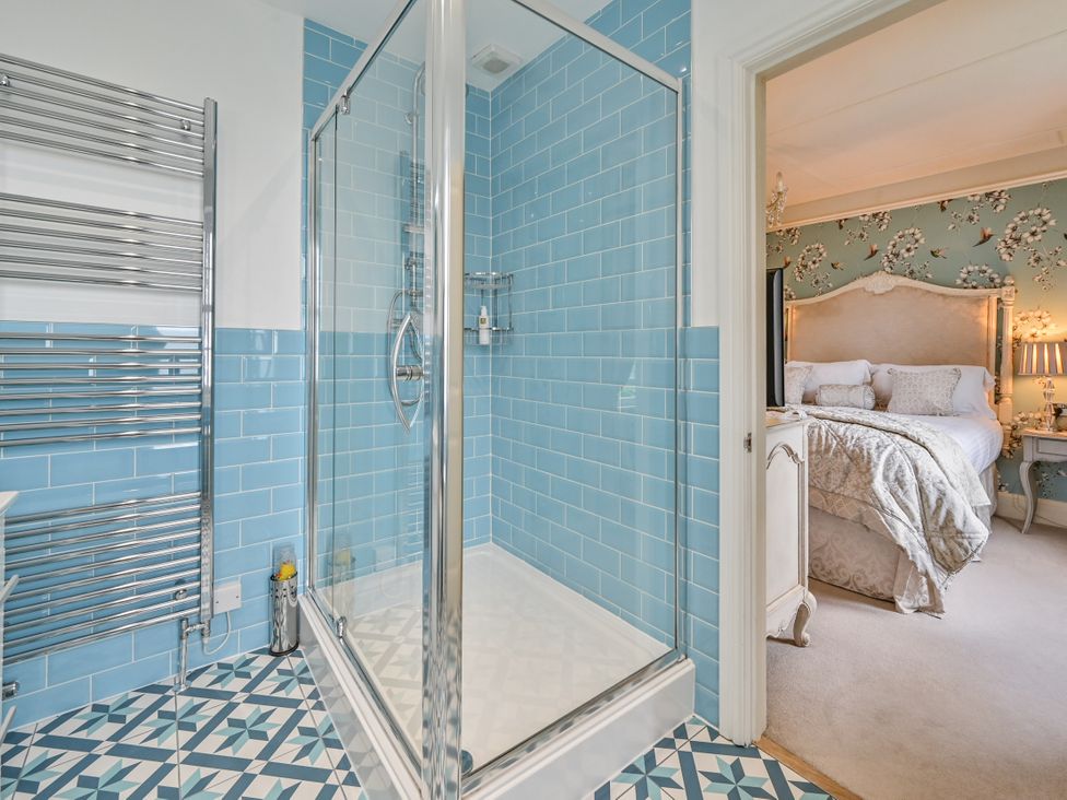 A bathroom with a shower and towel rail at Muntham Luxury Town House with Hot Tub, Torquay