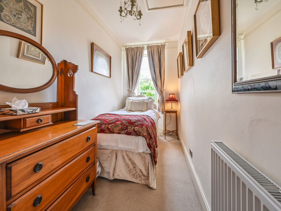 A bedroom with a bed and dresser at Muntham Luxury Town House with Hot Tub Torquay
