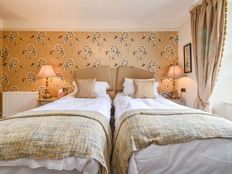A bedroom with two beds and lamps at Muntham Luxury Town House with Hot Tub Torquay