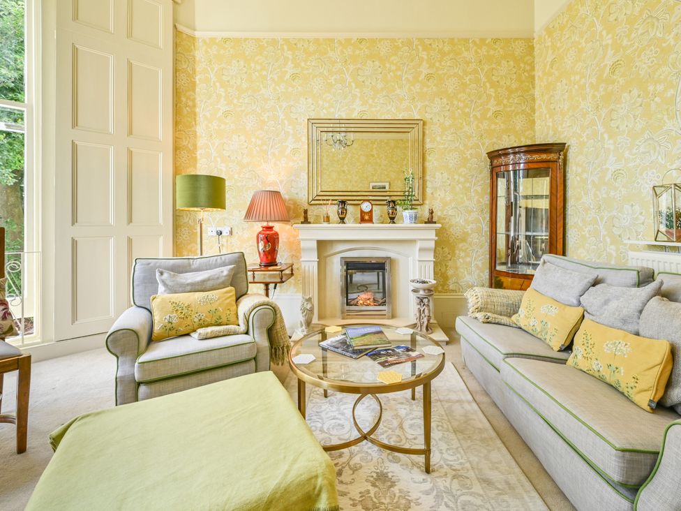 A living room with a sofa and coffee table at Muntham Deluxe Apartment 2 in Torquay