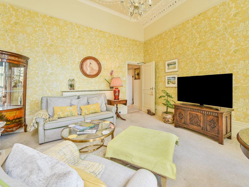 A living room with a television and sofa at Muntham Deluxe Apartment 2 in Torquay