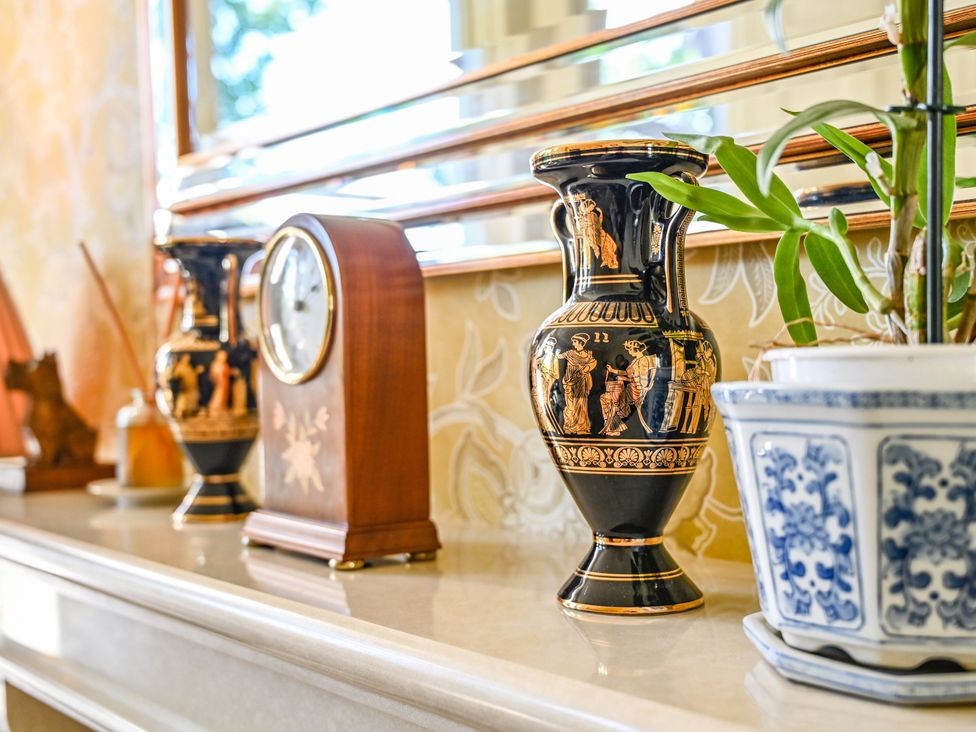 A living room with a vase and a clock at Muntham Deluxe Apartment 2 in Torquay