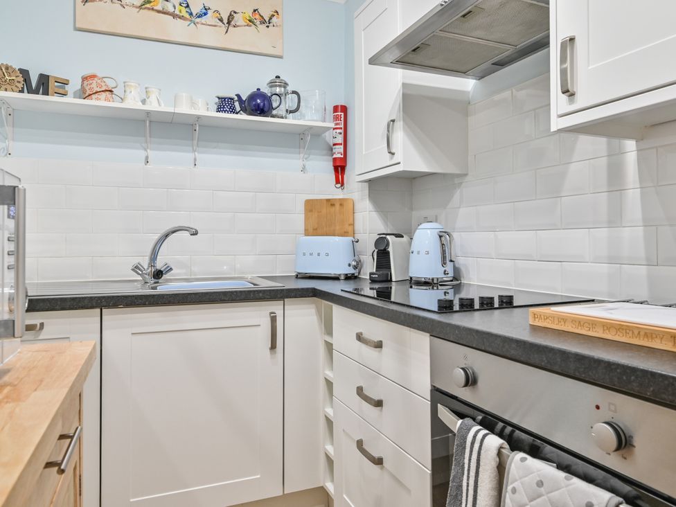 A kitchen with sink, cabinets, and appliances at Muntham Deluxe Apartment 2 in Torquay