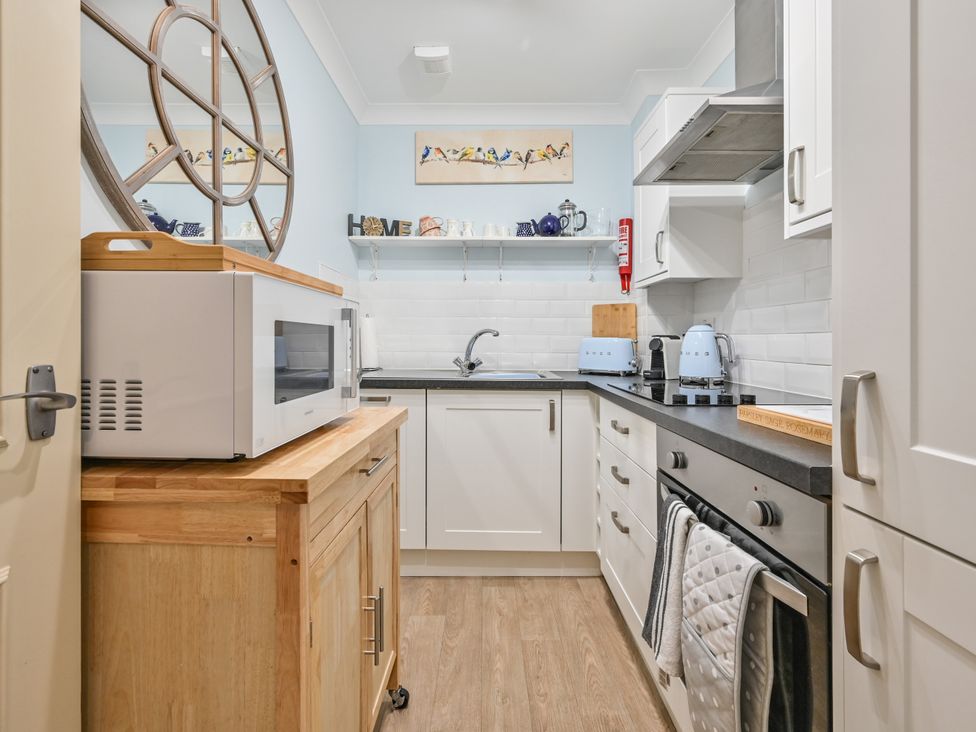 A kitchen with a microwave and kettle at Muntham Deluxe Apartment 2 Torquay