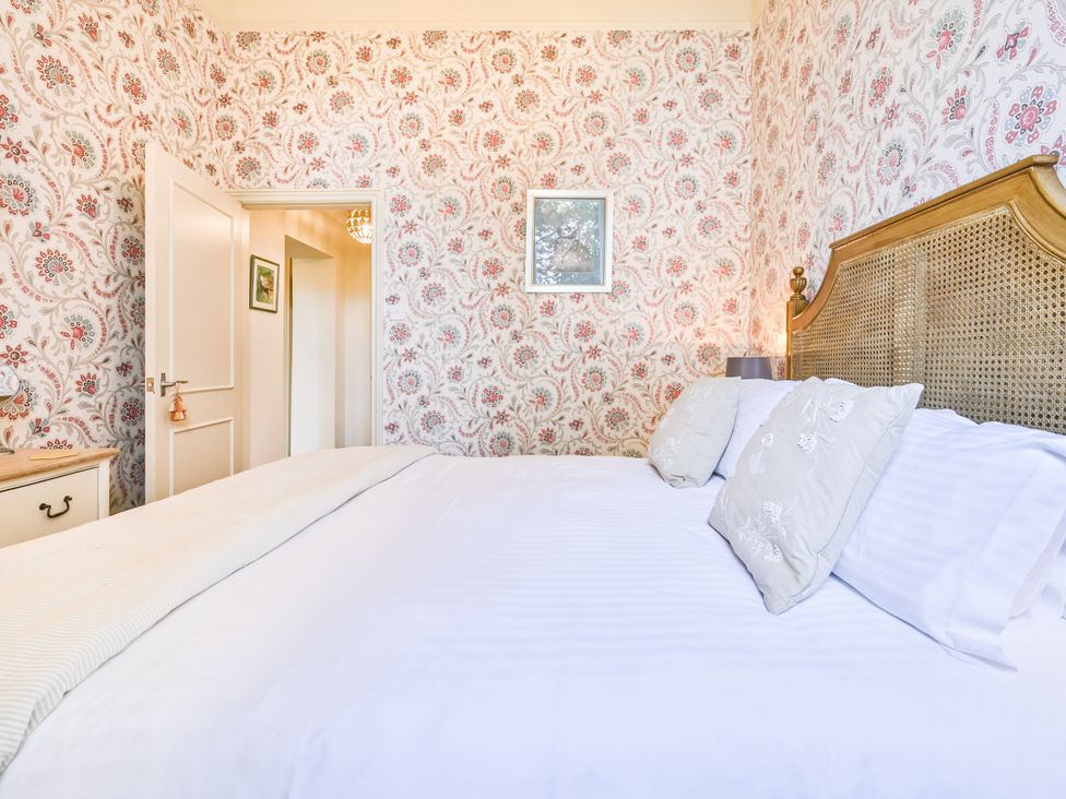 A bedroom with a bed and door at Muntham Deluxe Apartment 2 in Torquay