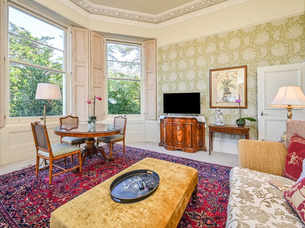 A living room with a table and chairs at Muntham Deluxe Apartment 3 in Torquay