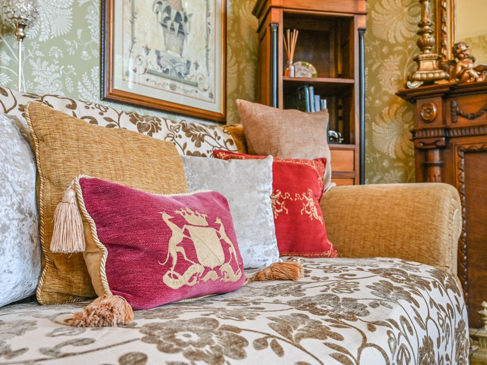 A living room with a sofa and decorative pillows at Muntham Deluxe Apartment 3 in Torquay