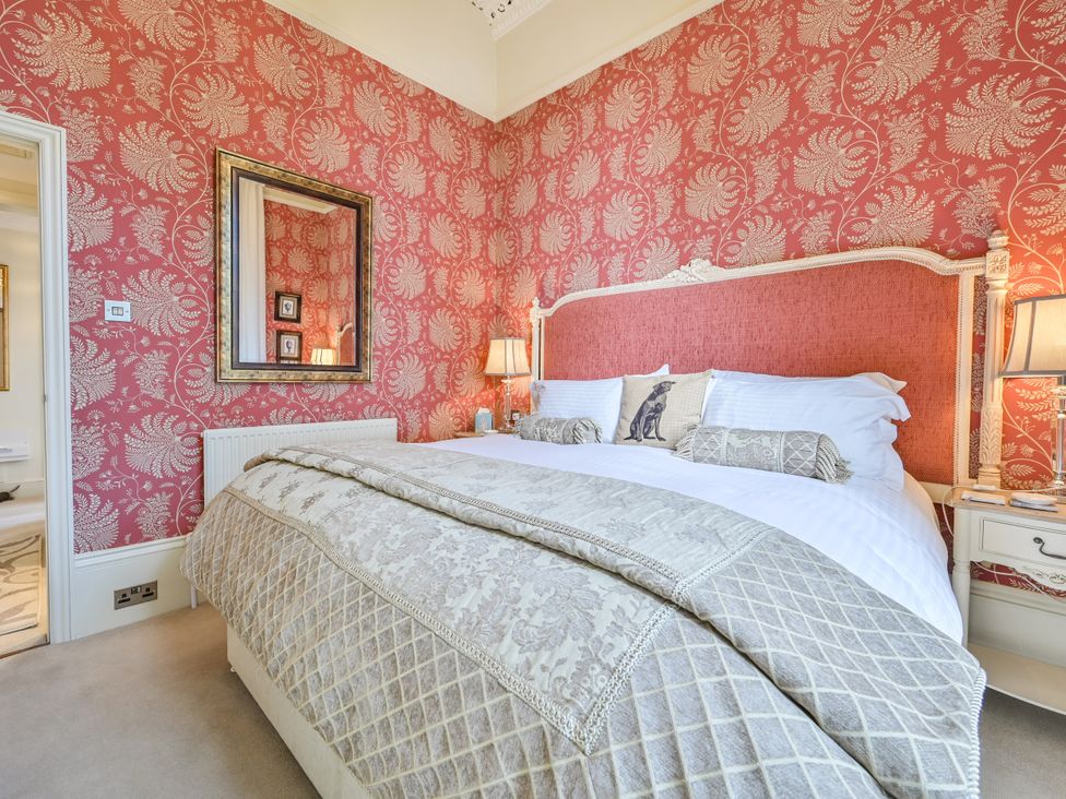A bedroom with a bed and bedside tables at Muntham Deluxe Apartment 3 in Torquay