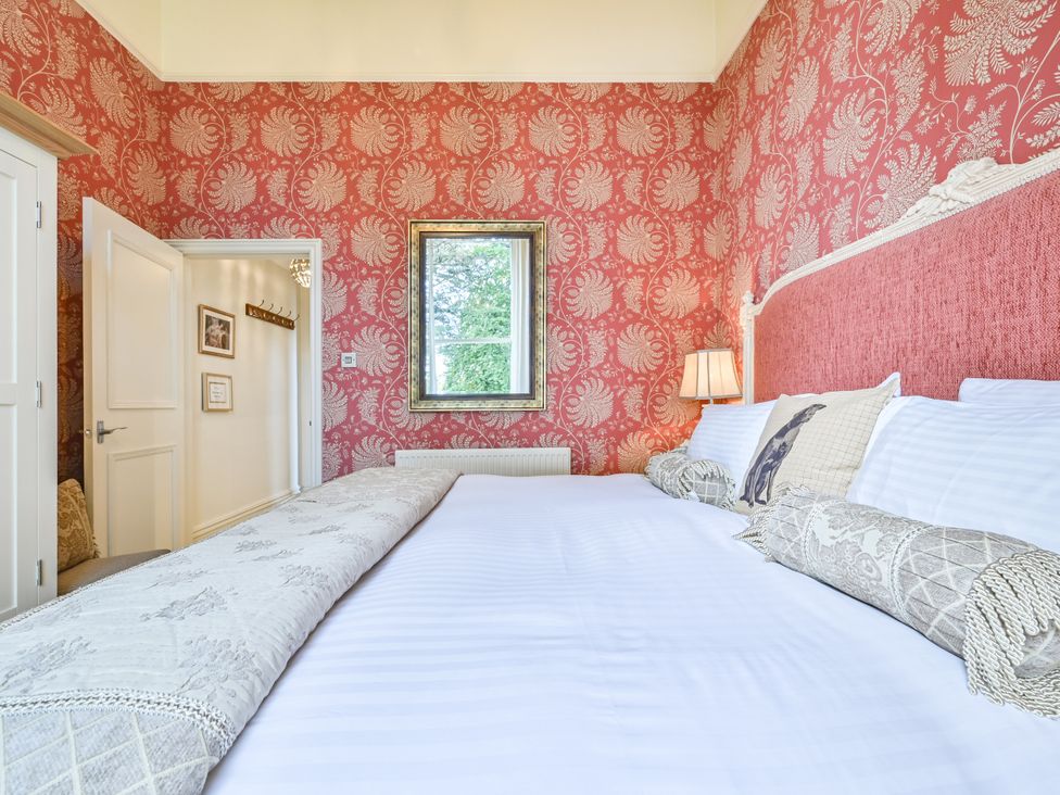 A bedroom with a bed and a window at Muntham Deluxe Apartment 3 in Torquay