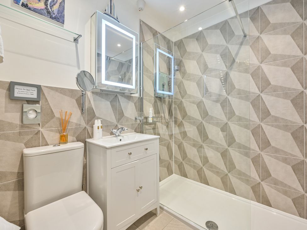 A bathroom with a shower, sink, and toilet at Muntham Deluxe Apartment 3, Torquay