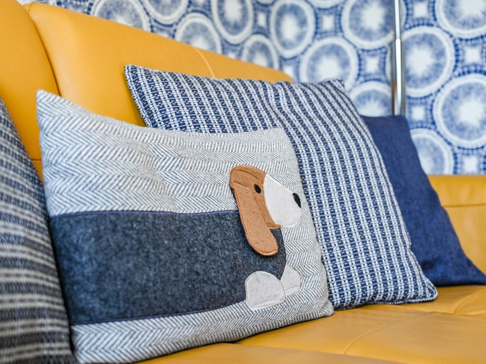 A sofa with cushions including a decorative pillow at Muntham Apartment 4 in Torquay