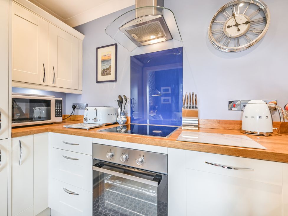 A kitchen with appliances and cabinetry at Muntham Apartment 4 in Torquay
