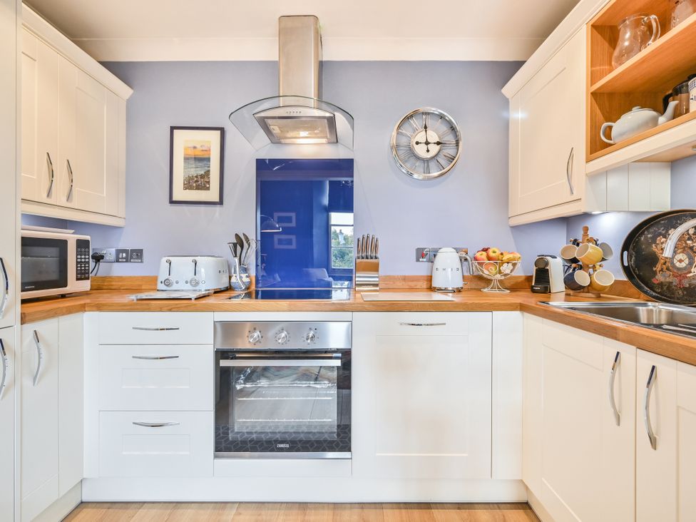 A kitchen with appliances and utensils at Muntham Apartment 4 Torquay
