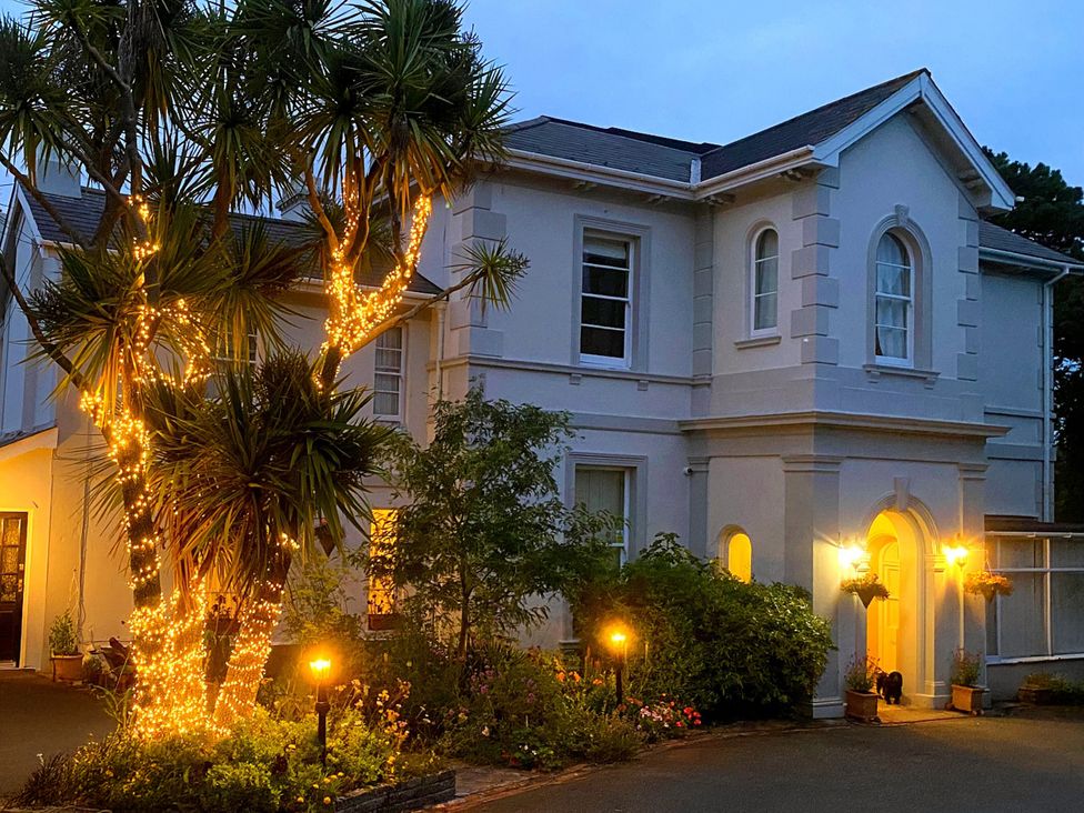 An outdoor view of a house with lights and plants at Muntham Apartment 4 in Torquay