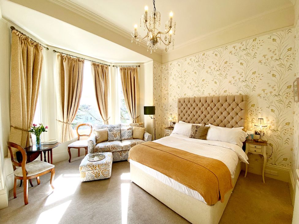 A bedroom with a bed and sofa at Muntham Studio Apartment 5 in Torquay