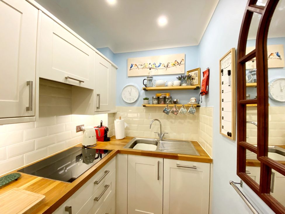 A kitchen with cabinets, sink, and stove at Muntham Studio Apartment 5 Torquay