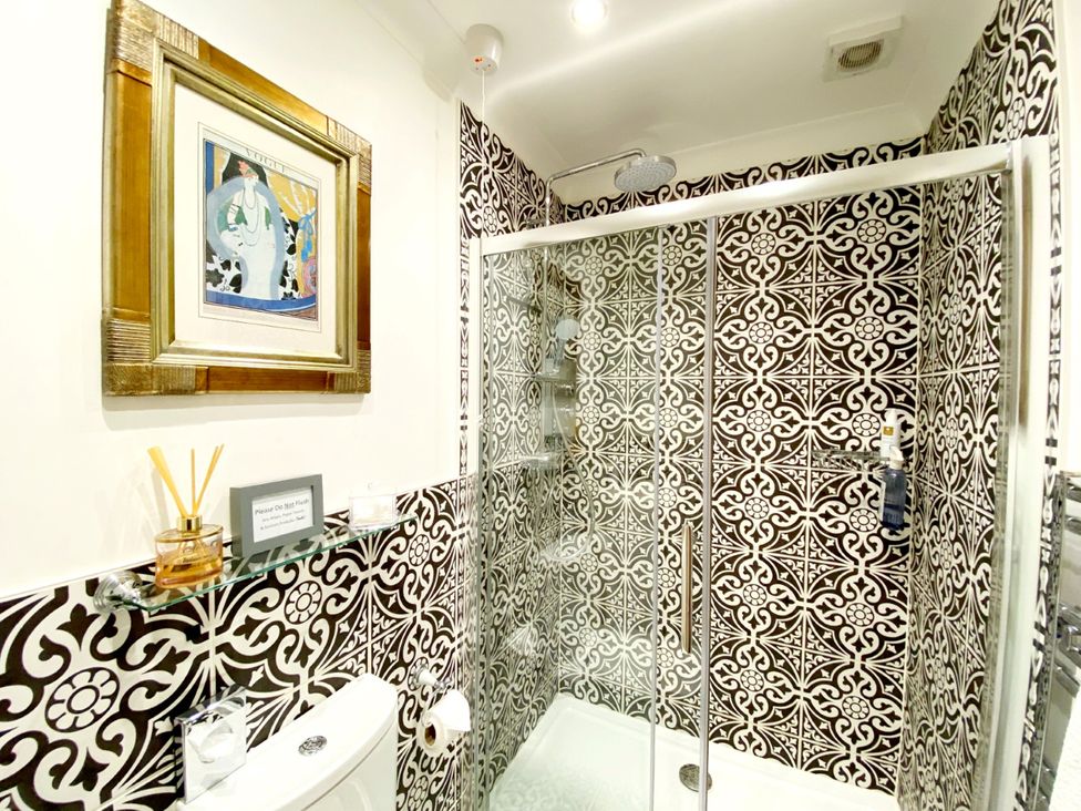 A bathroom with shower and toilet at Muntham Studio Apartment 5 in Torquay