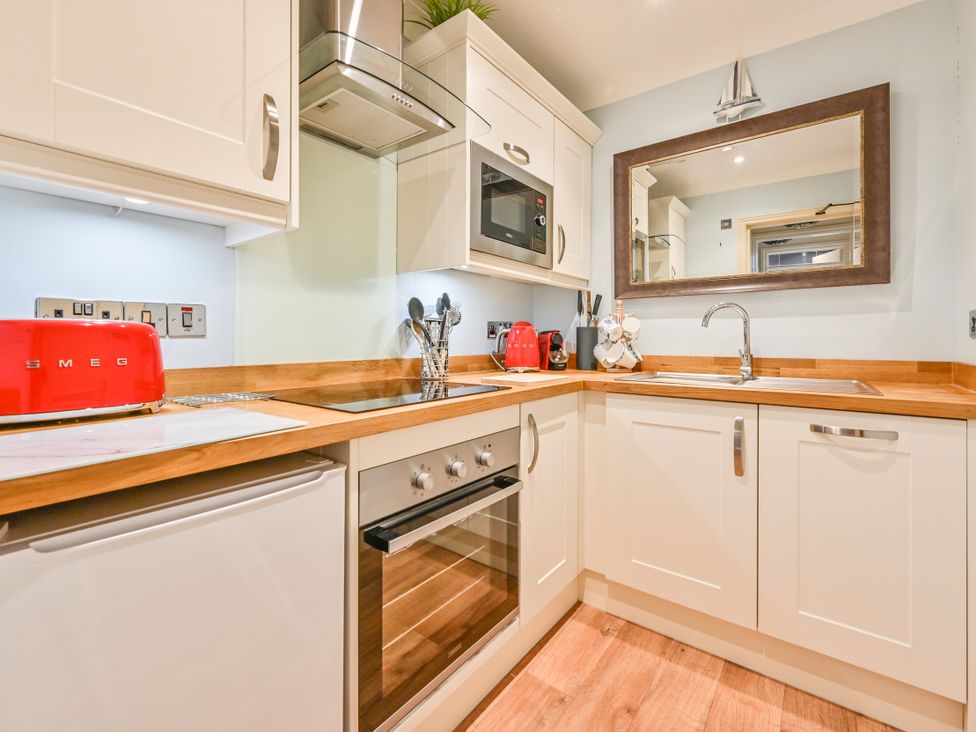 A kitchen with appliances and utensils at Muntham Apartment 6 in Torquay