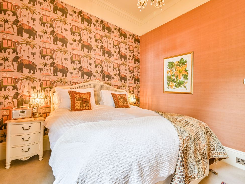 A bedroom with a bed and a nightstand at Muntham Apartment 6 in Torquay
