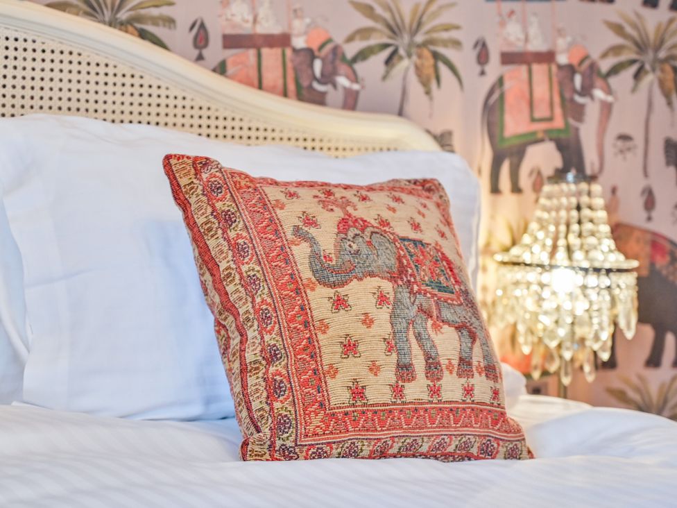 A pillow with an elephant design on a bed at Muntham Apartment 6 in Torquay