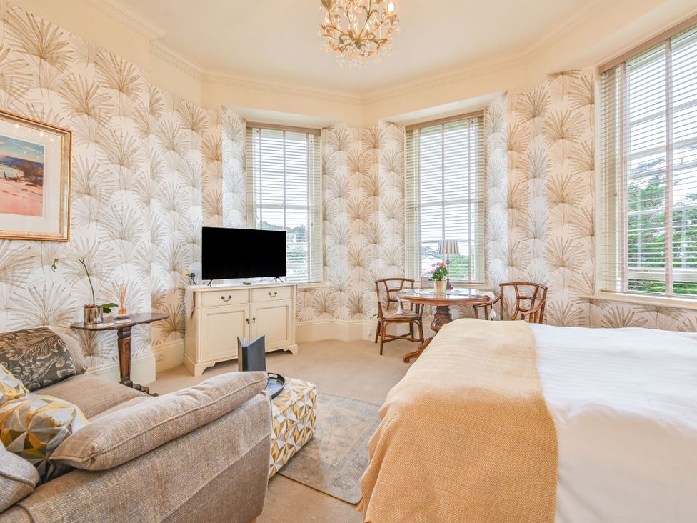 A studio with a sofa and a television at Muntham - Studio Apartment 7 in Torquay